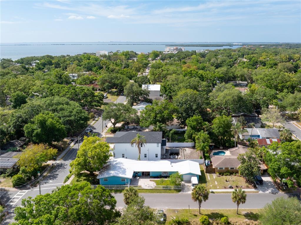 An aerial view shows a blue house with a white roof and a nearby pool — 685 1ST AVENUE N, SAFETY HARBOR, FL