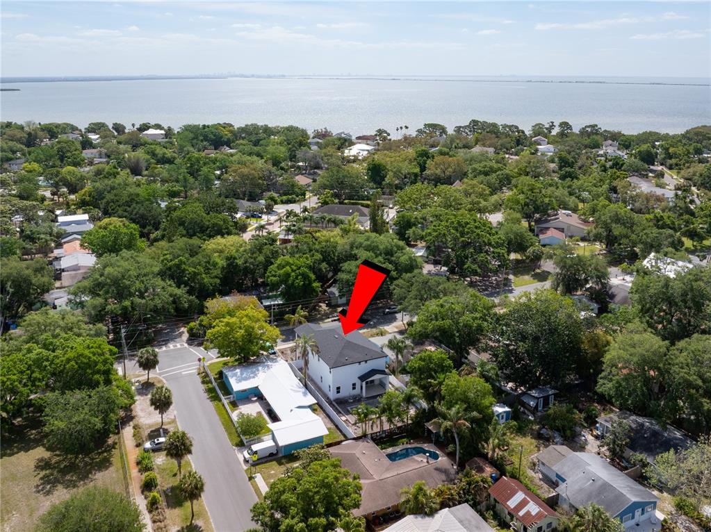 An aerial view shows a two-story house with a dark roof near a large body — 685 1ST AVENUE N, SAFETY HARBOR, FL