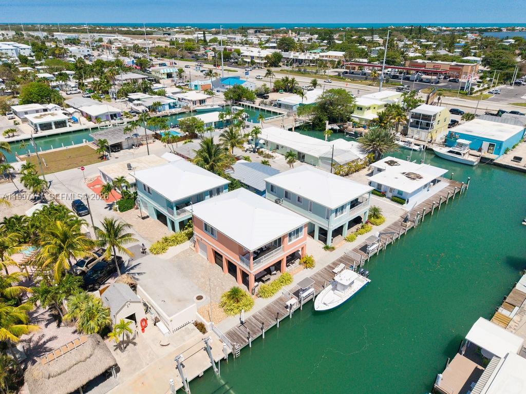 An aerial view shows waterfront houses with private docks and boats along a canal — 11284 3rd Avenue Ocean, Marathon FL 33050, MARATHON, FL