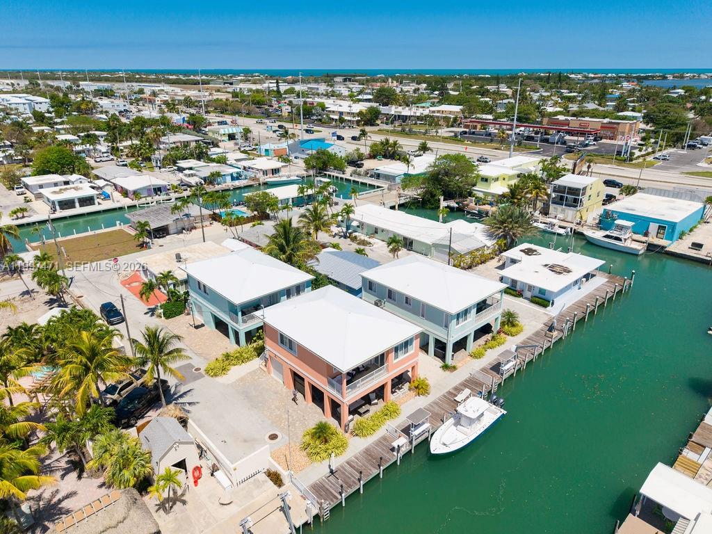 An aerial view shows waterfront houses with boat docks along a canal in Florida — 11284 3rd Avenue Ocean, Marathon FL 33050, MARATHON, FL
