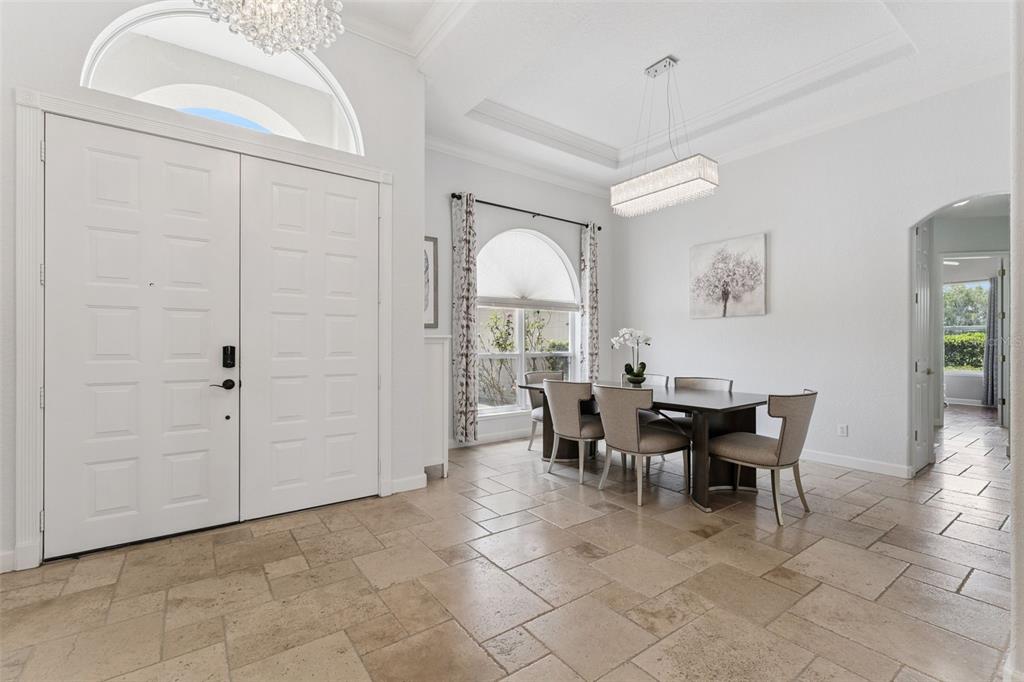 A dining area with a rectangular table, six chairs, and tile flooring near an entryway — 1700 LAKE ROBERTS COURT, WINDERMERE, FL