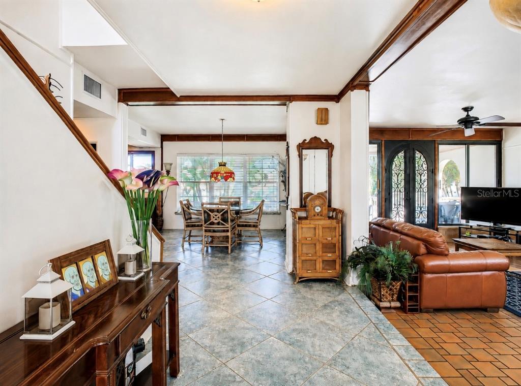 A view from a foyer looking into a dining area and a living room — 4929 N RIVER SHORE DRIVE UNIT A, TAMPA, FL