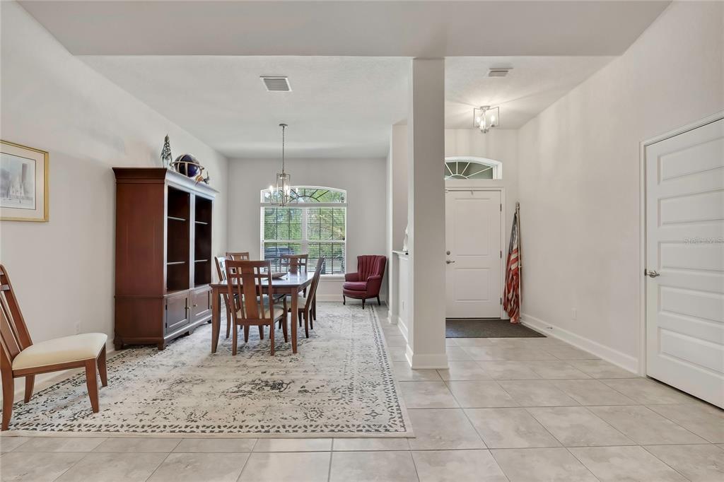 A dining room with a large hutch and table sits adjacent to an entryway — 24 TALL MARIGOLDS COURT, HOMOSASSA, FL