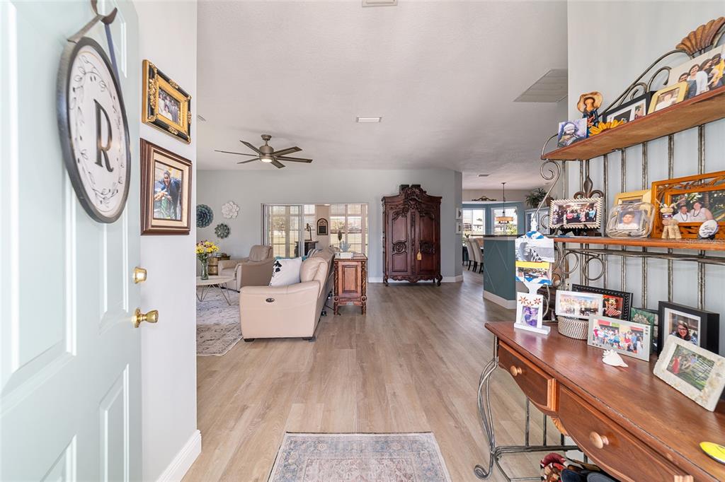 An entryway leads into an open-concept living area with light wood flooring and a hutch — 2380 NW 55TH AVENUE ROAD, OCALA, FL