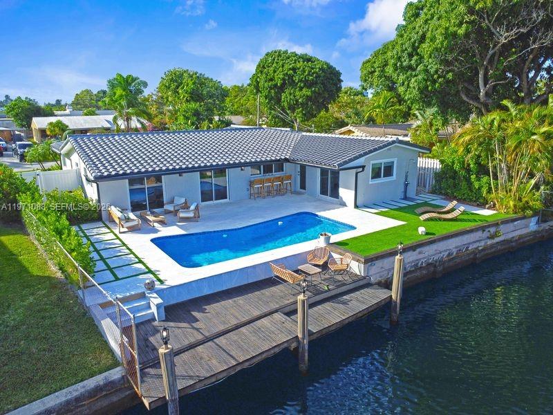 An aerial view of a house with a swimming pool and a wooden boat dock — 1810 SW 6th Ave, Pompano Beach FL 33060, POMPANO BEACH, FL