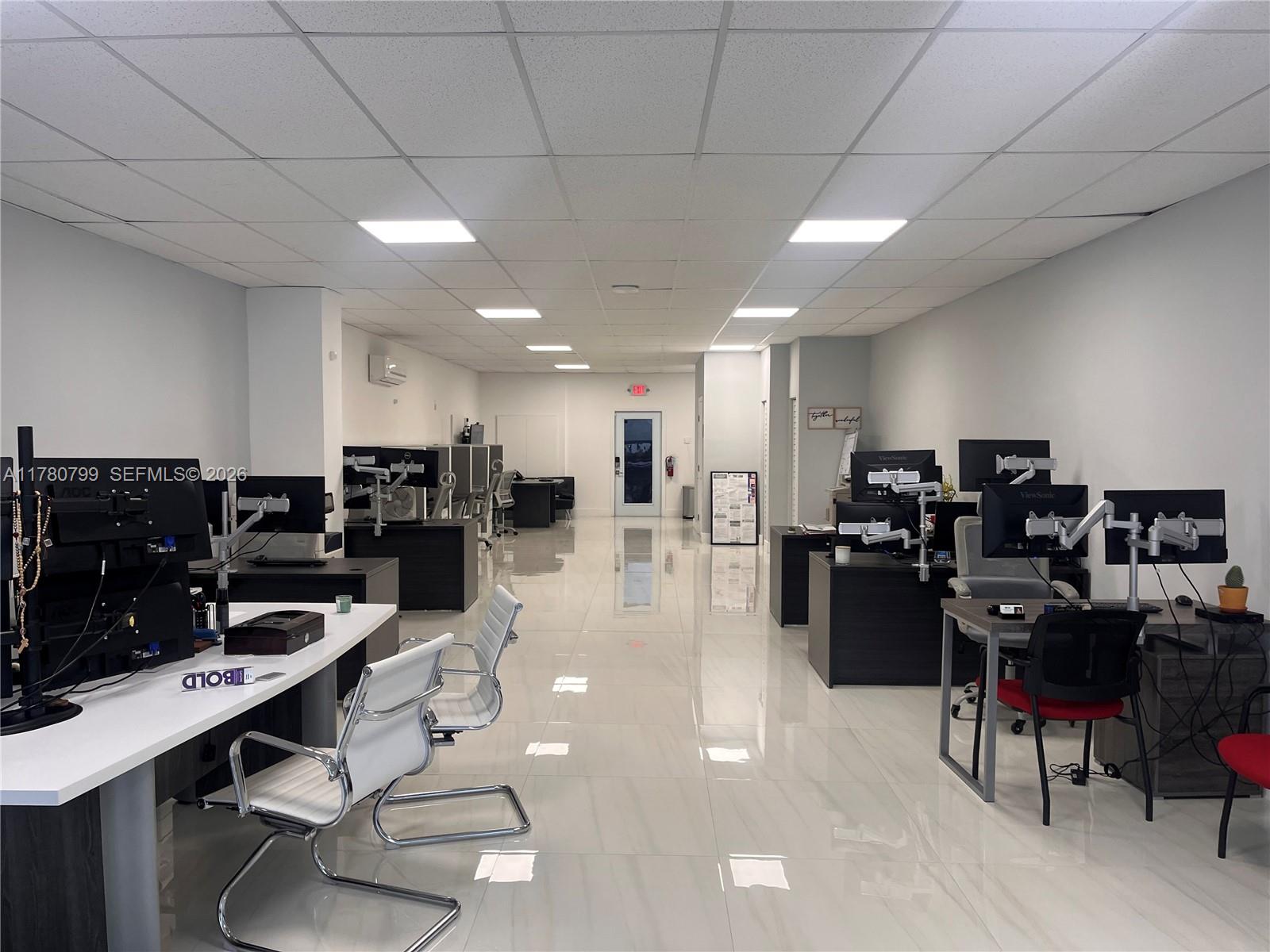 An office space features rows of desks with computer monitors, white chairs, and tiled floors — 2228 SW 67th Ave, Miami FL 33155, MIAMI, FL
