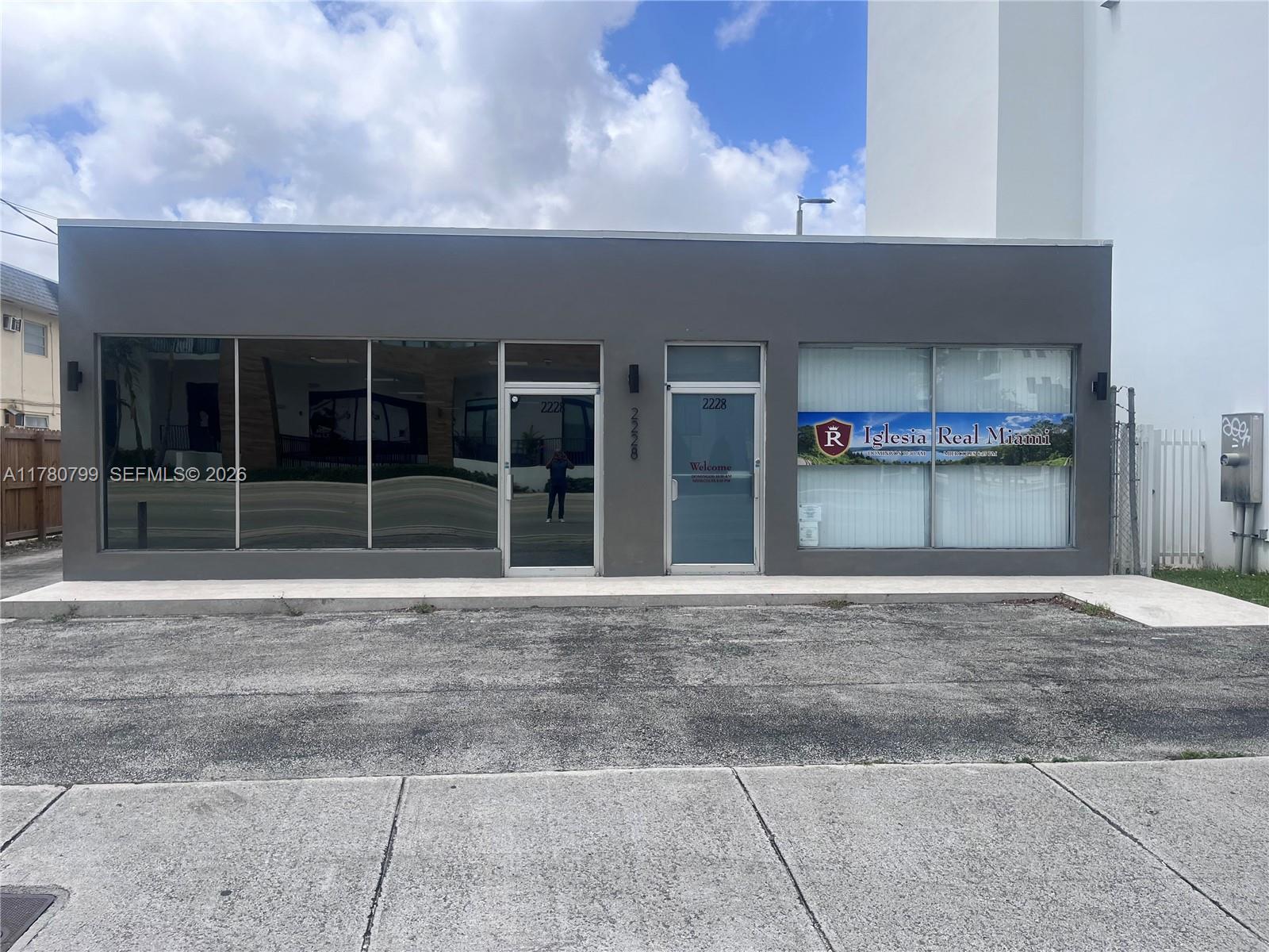 A gray commercial building exterior features large glass windows and two glass entry doors — 2228 SW 67th Ave, Miami FL 33155, MIAMI, FL