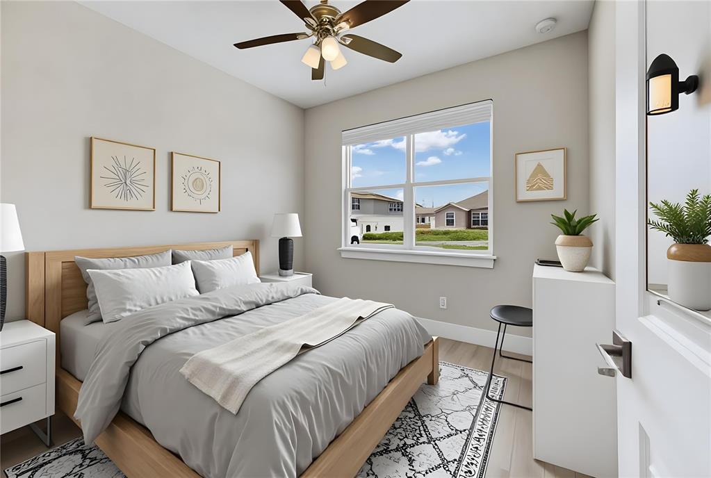 A bedroom features a wooden bed frame, light gray walls, and a window with exterior views — 804 COLVILLE DRIVE, KISSIMMEE, FL