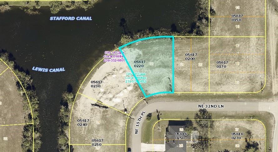 This is an aerial map showing a vacant waterfront lot highlighted in blue — 1515 NE 32ND LANE, CAPE CORAL, FL