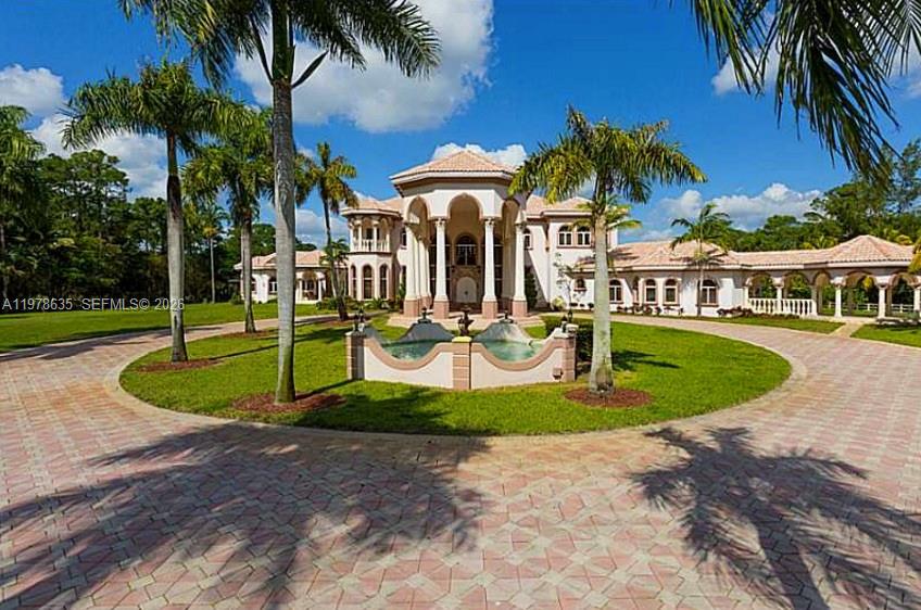 A large, multi-story Mediterranean-style mansion features a circular driveway and a front fountain — 21579 Cartagena Dr, Boca Raton FL 33428, BOCA RATON, FL