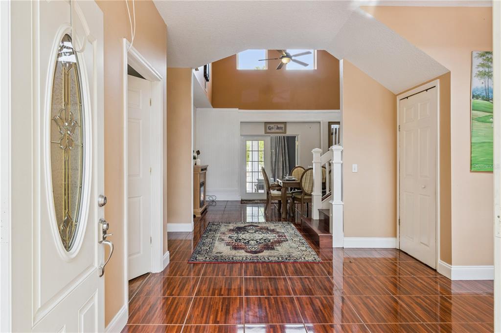 A bedroom features a large ornate headboard, a wooden armoire, and a gray recliner — 2606 ROYAL FERN PLACE, KISSIMMEE, FL