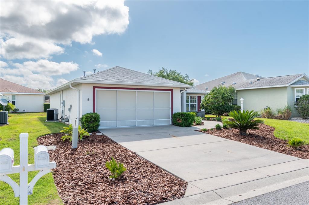A single-story house with a white stucco exterior, a two-car garage, and a concrete driveway — 8141 SW 80TH TERRACE, OCALA, FL