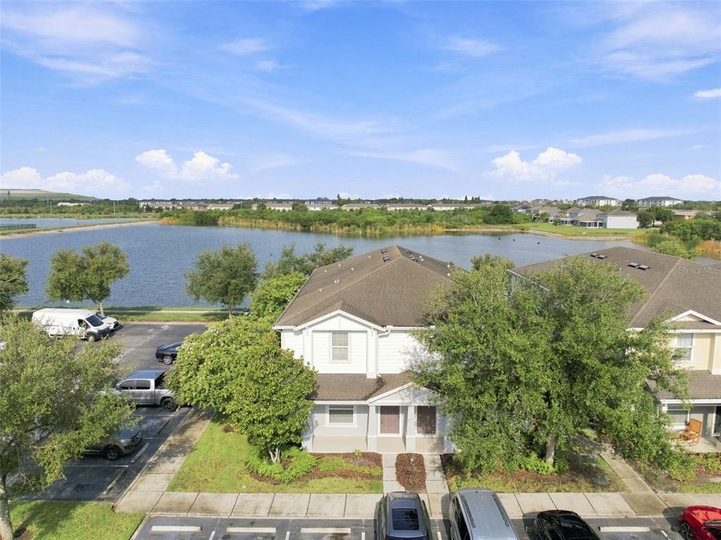 An aerial view shows a multi-story residential building next to a lake and parking lot — 4755 SOMERSET HILL LANE, RIVERVIEW, FL
