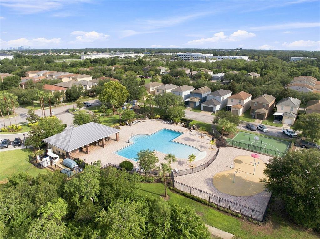 An aerial view shows a community swimming pool, splash pad, basketball court, and surrounding houses — 4755 SOMERSET HILL LANE, RIVERVIEW, FL