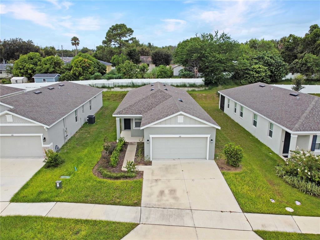 An aerial view of a suburban house with a gray roof and a concrete driveway — 832 BLUE CREEK DRIVE, HAINES CITY, FL