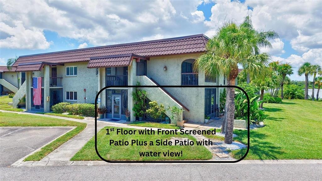 The exterior of a two-story apartment building features a ground-floor unit with screened patios — 1001 S BAYSHORE BOULEVARD UNIT 101, SAFETY HARBOR, FL