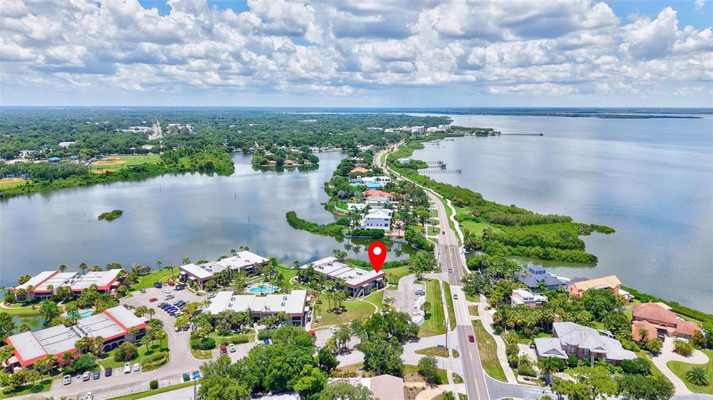 An aerial view shows a waterfront complex with a red location pin on a building — 1001 S BAYSHORE BOULEVARD UNIT 101, SAFETY HARBOR, FL
