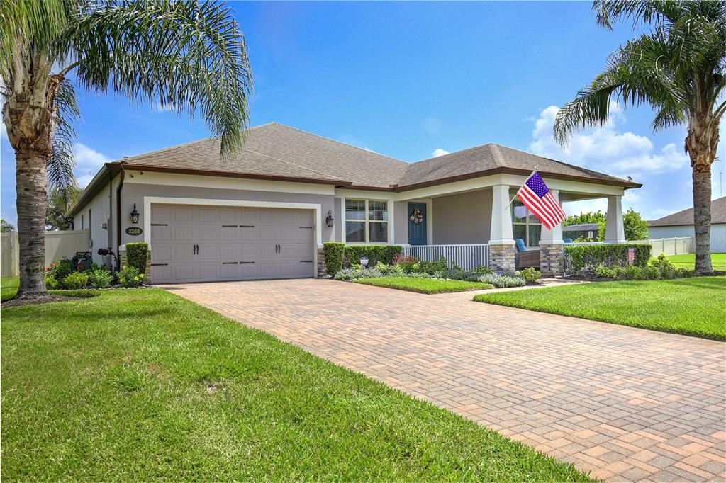 A single-story house with a paved driveway, a two-car garage, and a covered front porch — 3266 KAYAK WAY, ORLANDO, FL
