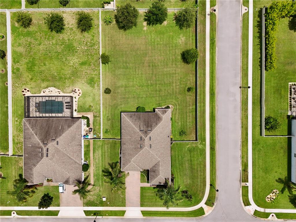 An aerial view shows two residential houses with large backyards and a street — 3266 KAYAK WAY, ORLANDO, FL