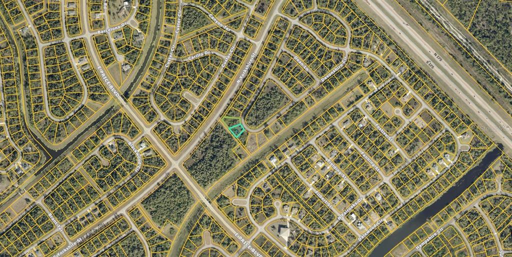 This is an aerial map showing a vacant lot highlighted in a residential neighborhood — 1131209841 & 1131209842 DEVONSHIRE CIRCLE, NORTH PORT, FL