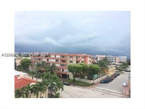 An elevated view shows a multi-story apartment building with palm trees and a parking lot — 7740 Abbott Ave # 5B, Miami Beach FL 33141, MIAMI BEACH, FL