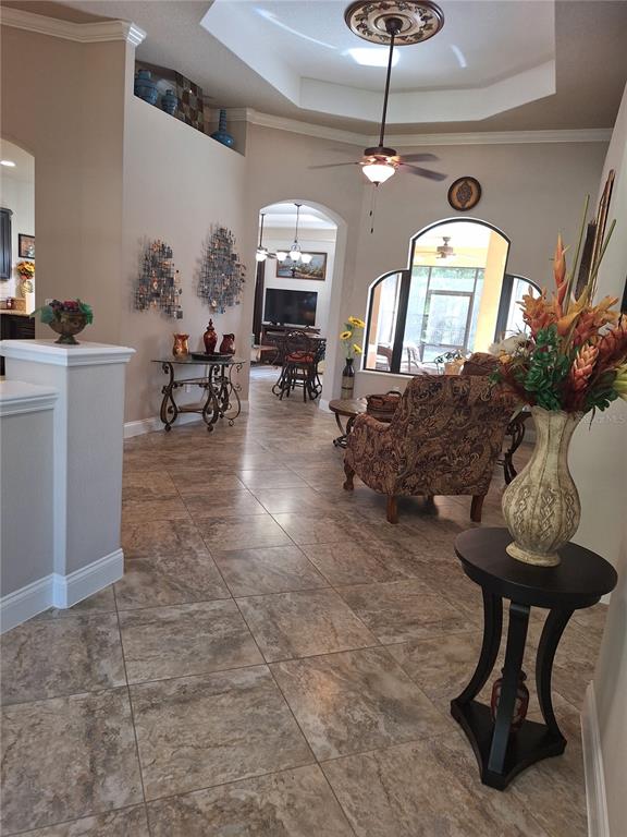 A tiled entryway leads into a living room with a tray ceiling and arched windows — 29 N LAKEWALK DRIVE, PALM COAST, FL
