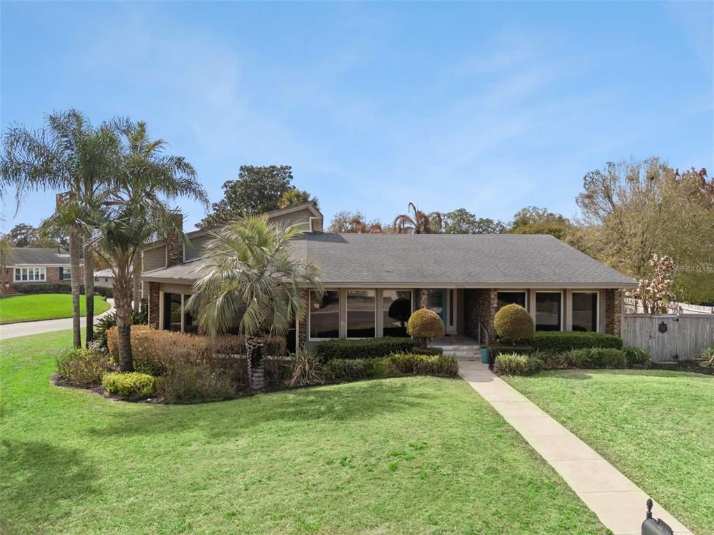 A single-story house with a gray shingled roof, brick facade, and palm trees in front — 3226 S OSCEOLA AVENUE, ORLANDO, FL