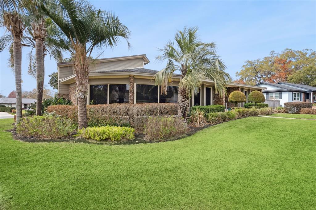 A single-story house with stone accents, large windows, and palm trees in the front yard — 3226 S OSCEOLA AVENUE, ORLANDO, FL