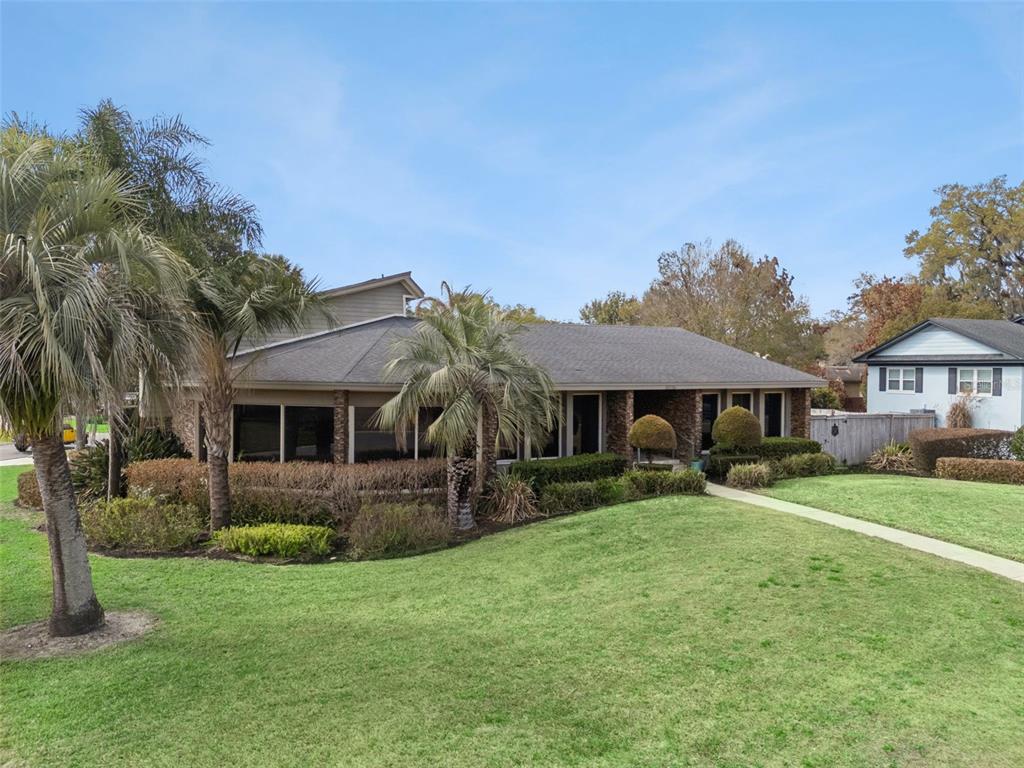 A single-story house with a brick facade, large windows, and palm trees on a lawn — 3226 S OSCEOLA AVENUE, ORLANDO, FL