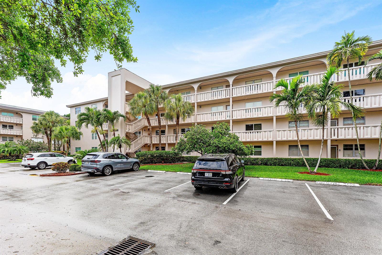 A multi-story apartment building with balconies and a parking lot in the foreground — 3301 Aruba Way # C1, Coconut Creek FL 33066, COCONUT CREEK, FL
