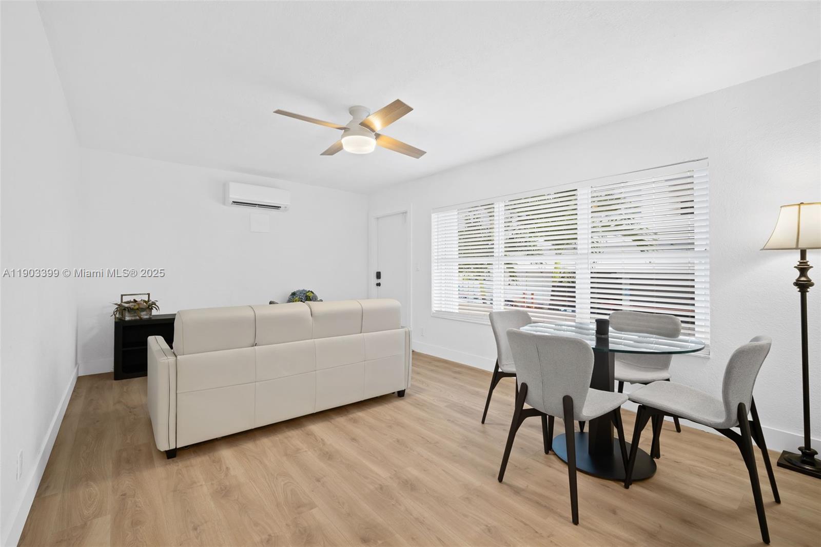 A living and dining area features white walls, light wood flooring, and a ceiling fan — 9241 Collins Ave # 11, Surfside FL 33154, SURFSIDE, FL