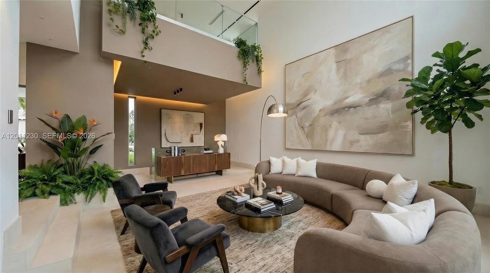 A modern living room features a curved sofa, two armchairs, and large abstract wall art — 3280 Lake Ridge Lane, Weston FL 33332, WESTON, FL