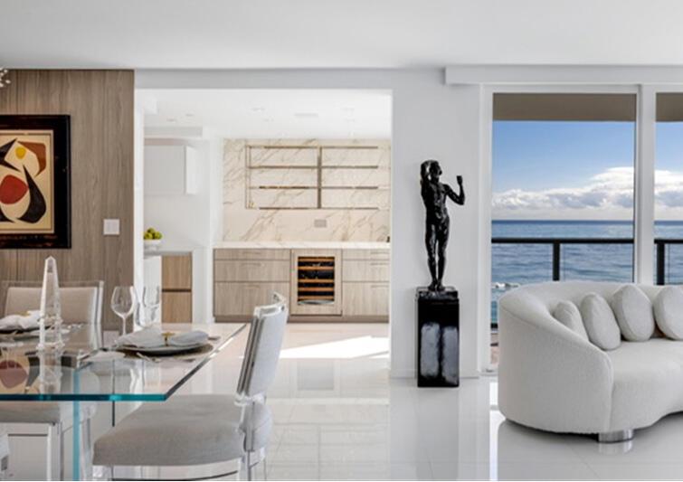 A modern dining and living area features a glass table, white sofa, and ocean view — 3440 S Ocean Boulevard # 708s, Palm Beach FL 33480, PALM BEACH, FL