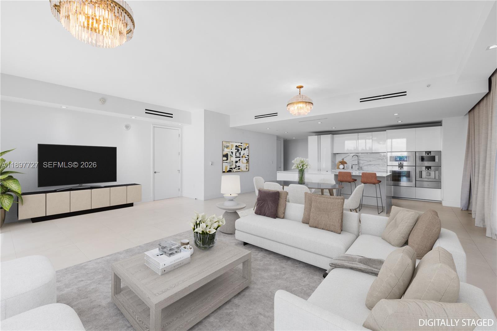 This digitally staged open-concept living and dining area features white walls, tile floors, and chandeliers — 10201 Collins Ave # 311, Bal Harbour FL 33154, BAL HARBOUR, FL