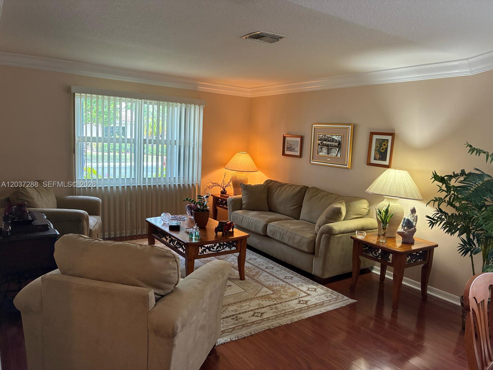 A living room features a sofa, two armchairs, a coffee table, and hardwood flooring — 1412 NW 129th Terrace, Sunrise FL 33323, SUNRISE, FL