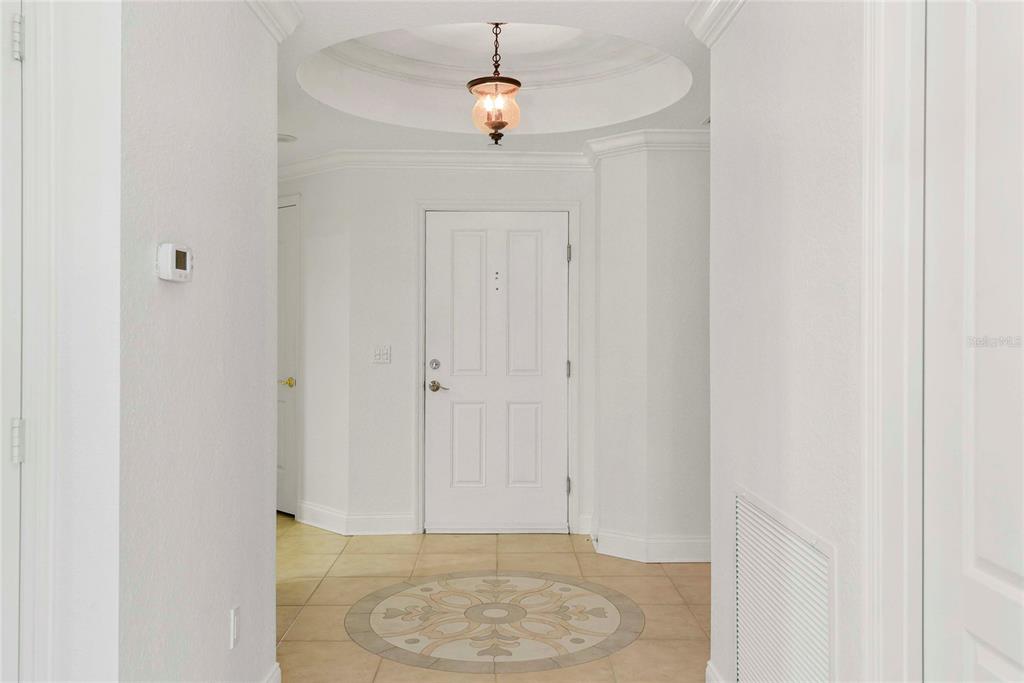 A white entryway features a tiled floor with a decorative medallion and a domed ceiling — 261 MINORCA BEACH WAY UNIT 606, NEW SMYRNA BEACH, FL