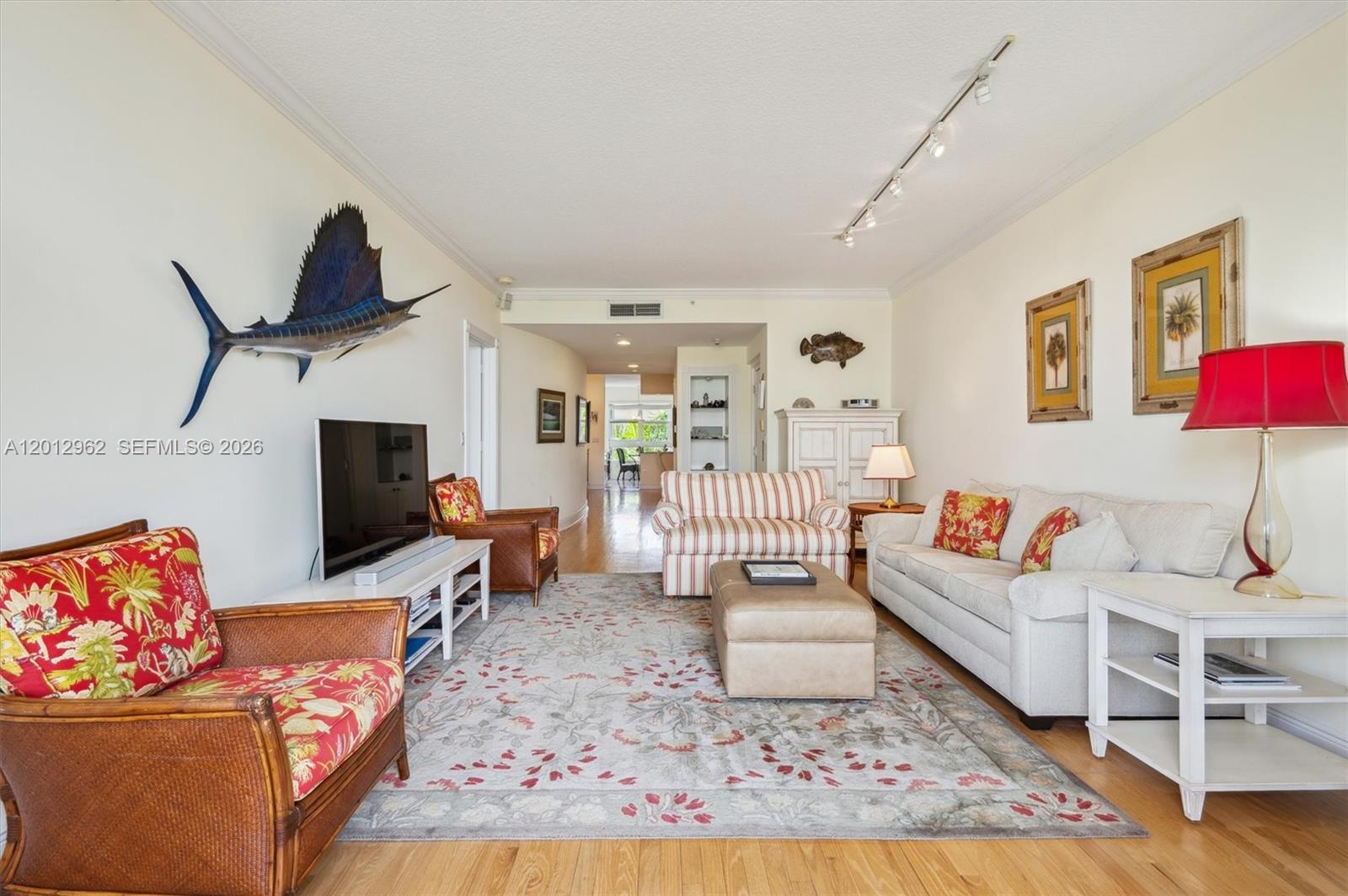 A living room features a large area rug, a sofa, armchairs, and a mounted fish — 701 Crandon Blvd # 1, Key Biscayne FL 33149, KEY BISCAYNE, FL