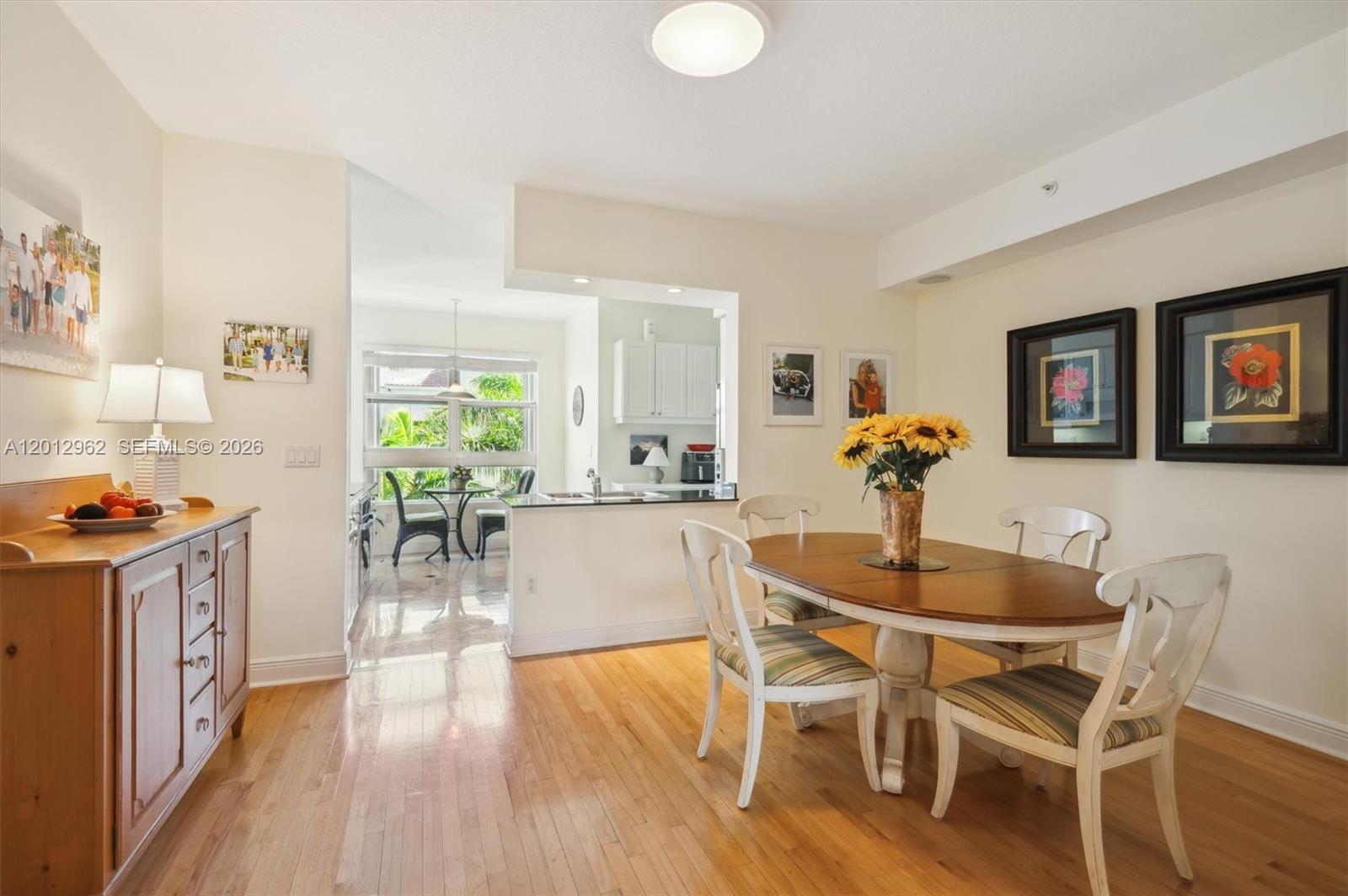 A dining area with a wooden table and chairs sits adjacent to a kitchen — 701 Crandon Blvd # 1, Key Biscayne FL 33149, KEY BISCAYNE, FL
