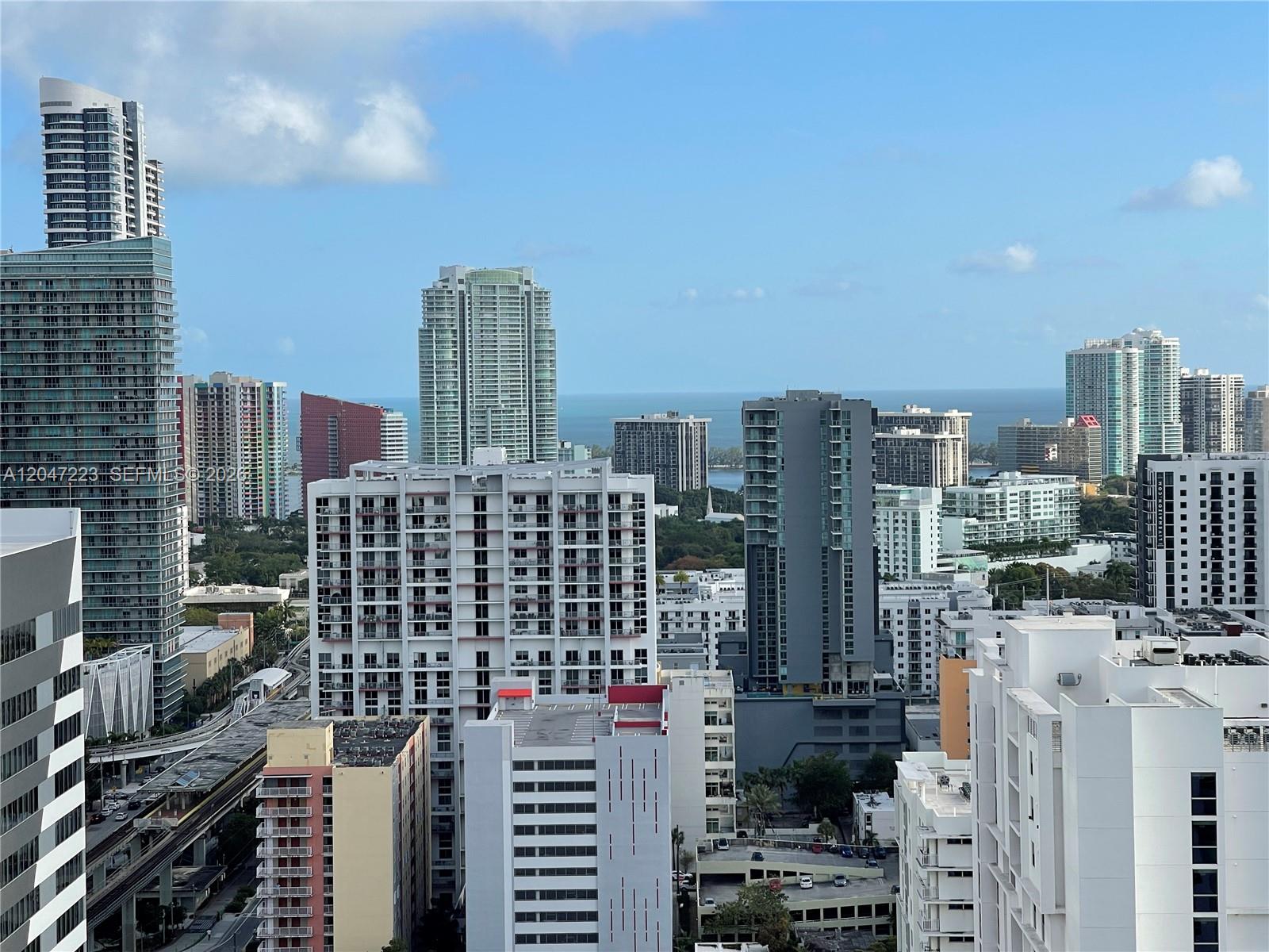 An elevated view of a dense urban skyline with numerous high-rise residential buildings — 690 SW 1st Ct # 3115, Miami FL 33130, MIAMI, FL