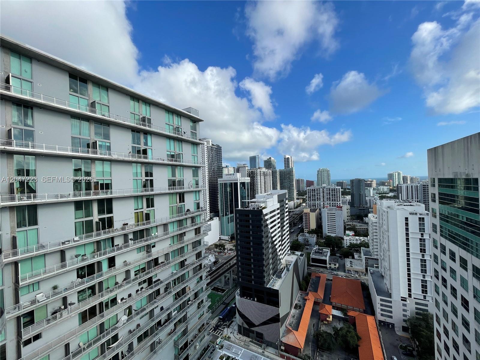 An elevated view of a dense urban skyline featuring several modern high-rise apartment buildings — 690 SW 1st Ct # 3115, Miami FL 33130, MIAMI, FL