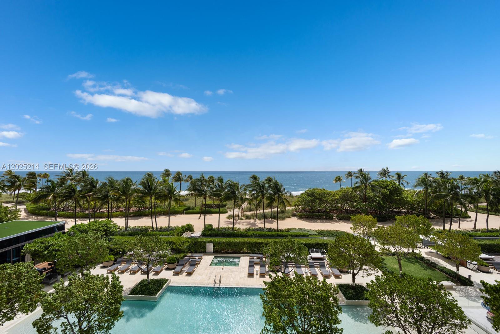 An elevated view of a swimming pool, palm trees, and a sandy beach by the ocean — 10203 Collins Ave # 403, Bal Harbour FL 33154, BAL HARBOUR, FL