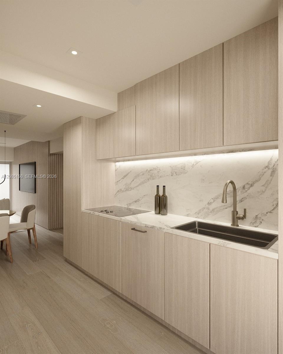 This is a rendering of a modern kitchen with light wood cabinetry and marble countertops — 250 Collins Ave # 107, Miami Beach FL 33139, MIAMI BEACH, FL