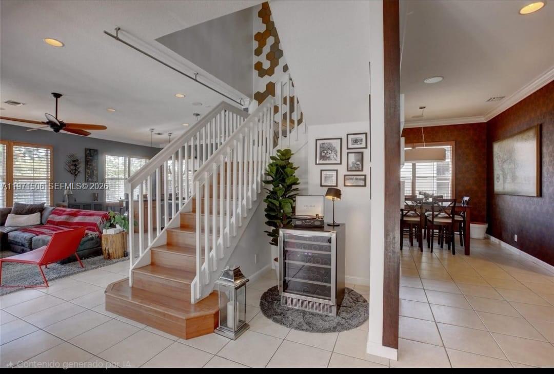 A staircase with wooden treads and white railings stands in a tiled foyer — 2789 SW 130th Ter, Miramar FL 33027, MIRAMAR, FL