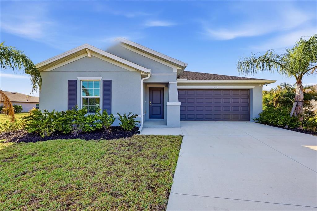 A single-story house with a light blue exterior, dark shutters, and a two-car garage — 113 LILYAN COURT, ROTONDA WEST, FL