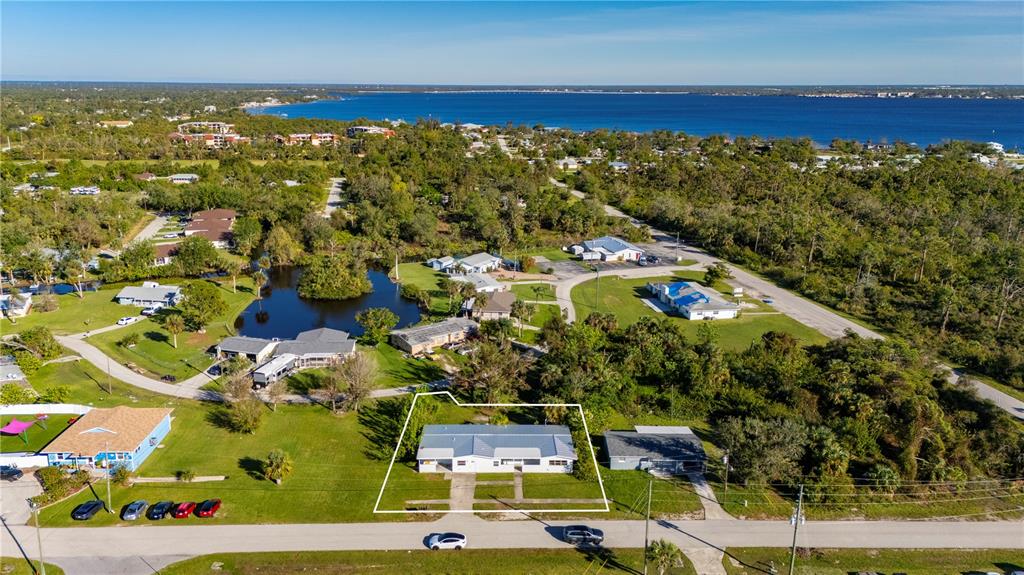 An aerial view shows a single-story house with a white outline on a grassy lot — 4362 PINNACLE STREET, PUNTA GORDA, FL