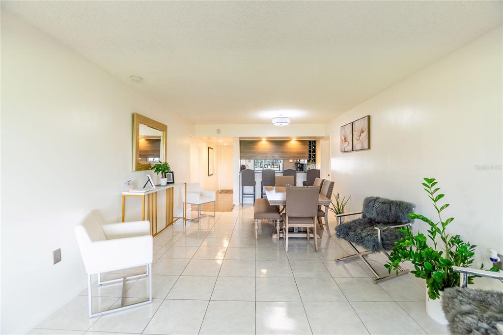 A dining area with tile floors, a table with chairs, and a kitchen counter — 1508 WHITEHALL DRIVE UNIT 206, DAVIE, FL
