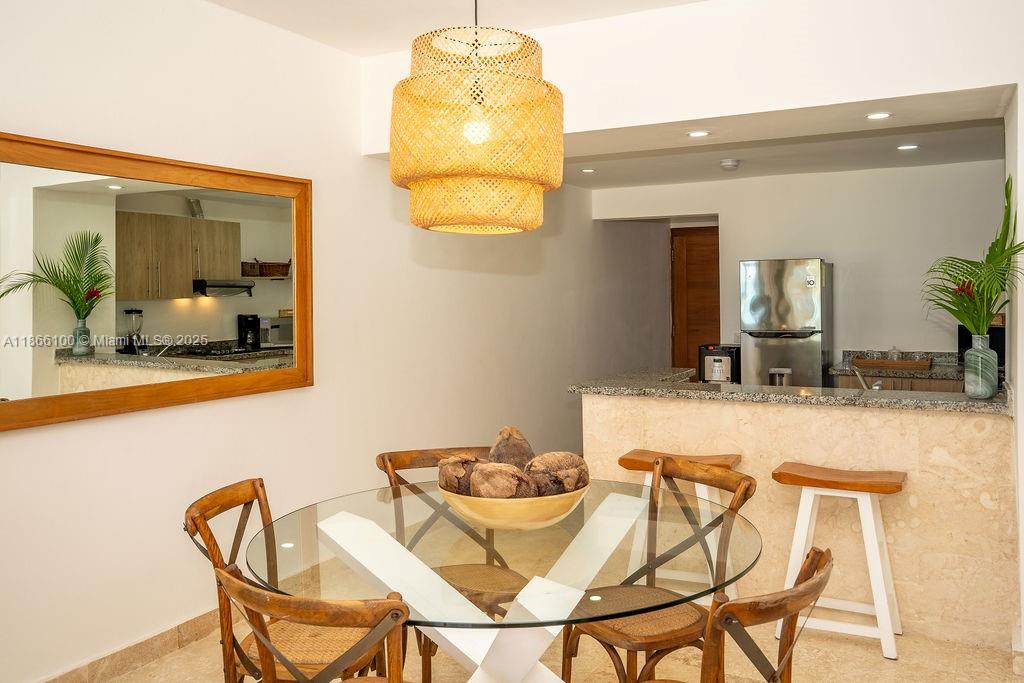 A dining area features a glass table, wooden chairs, and a woven pendant light fixture — 000 8C3F+Q62, Las Terrenas 32000, Dominican Republic # 2, DR, DR