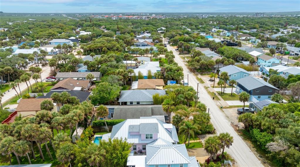 A pink, single-story house with a metal roof, front porch, and a gravel walkway — 915 MAPLE STREET, NEW SMYRNA BEACH, FL
