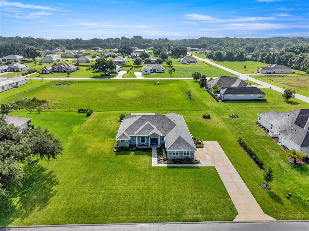 An aerial view shows a single-story house with a gray roof and large green lawn — 7835 SE 22ND TERRACE, OCALA, FL
