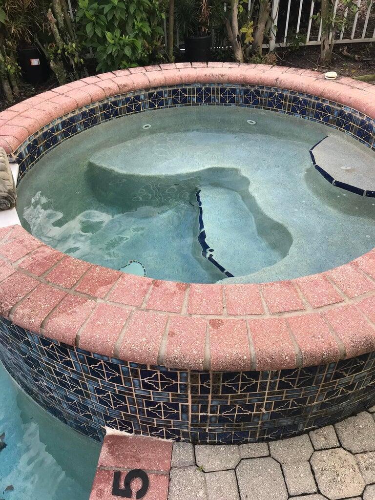 An elevated circular spa with blue tile accents and a red brick coping edge — 17275 Ventana Drive, Boca Raton FL 33487, BOCA RATON, FL
